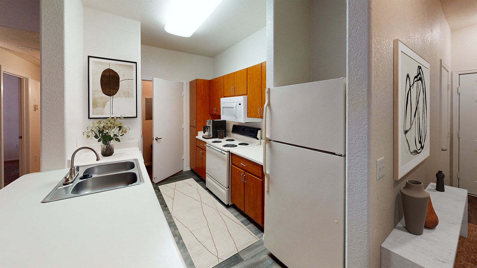 a kitchen with white appliances and a sink and a refrigerator