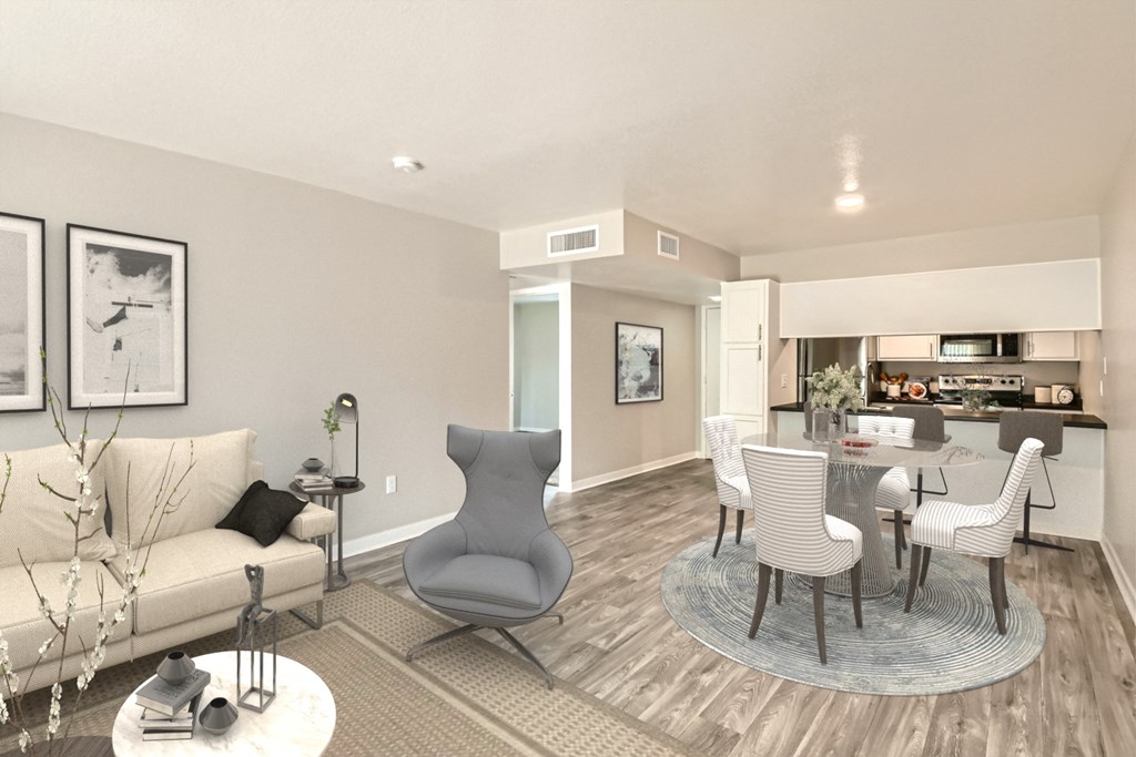 a living room with a couch and chairs and a dining table