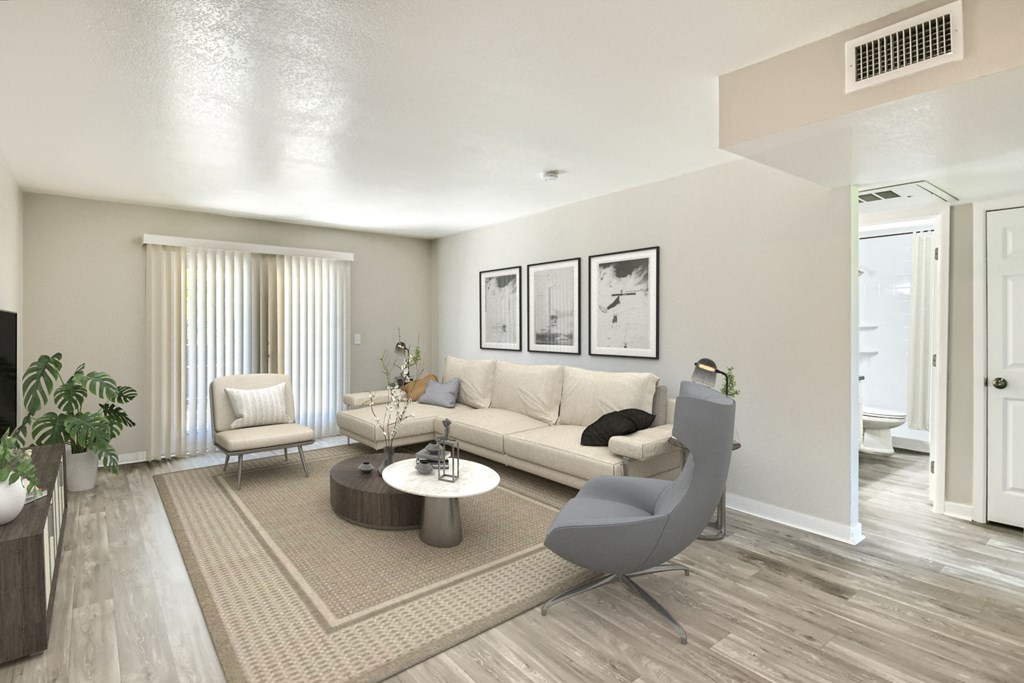 the living room of an apartment with a couch and a chair