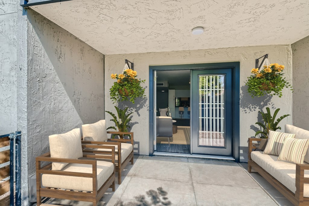 a patio with chairs and a door to a room