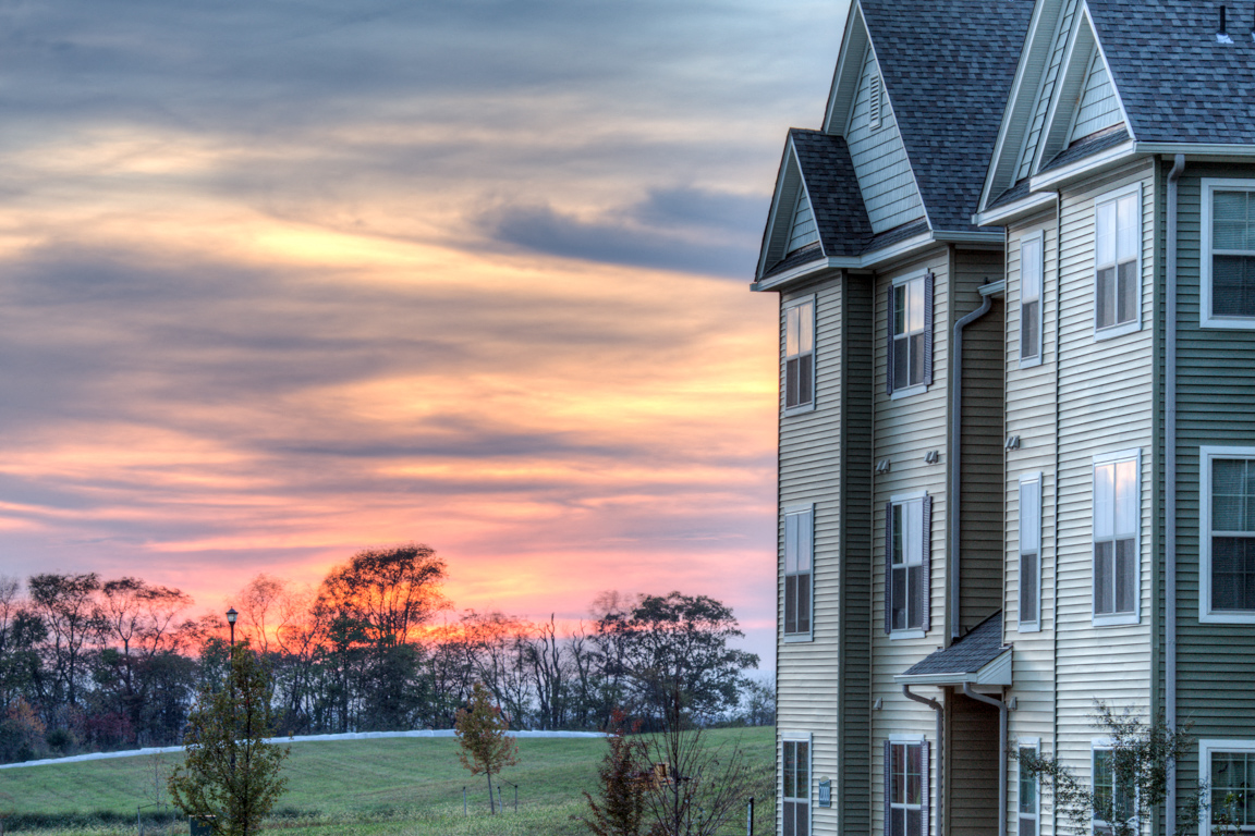 a view of a house with a sunset in the background