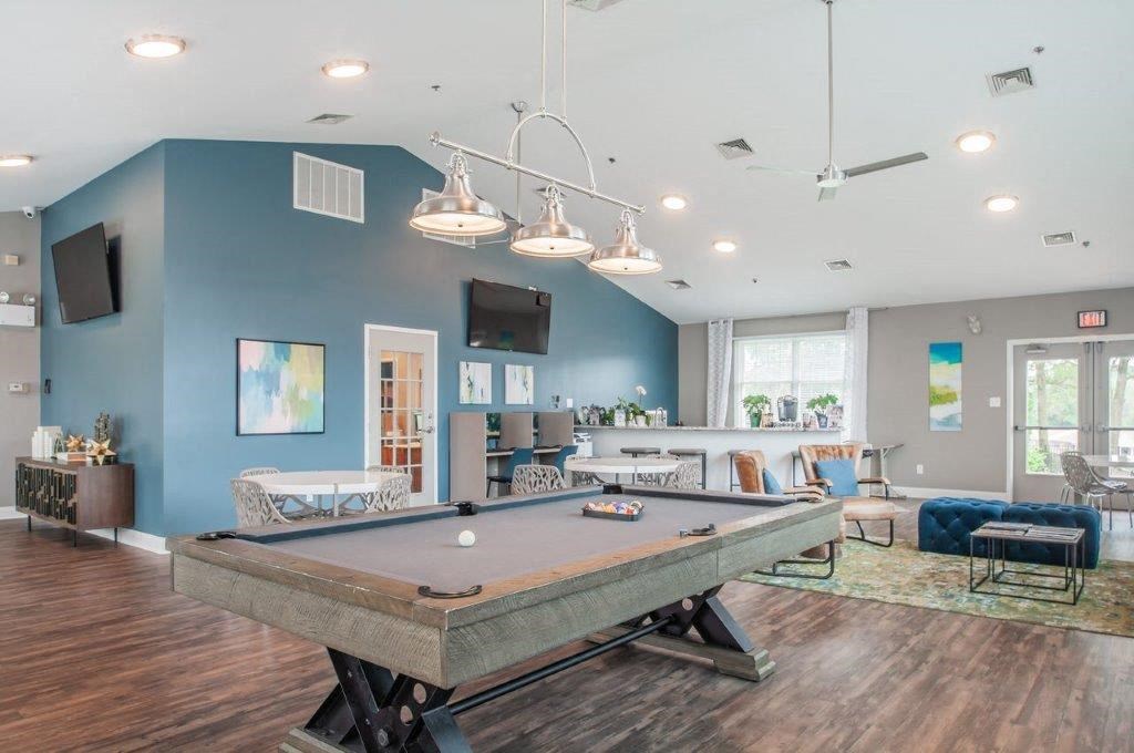 a game room with a pool table and a television