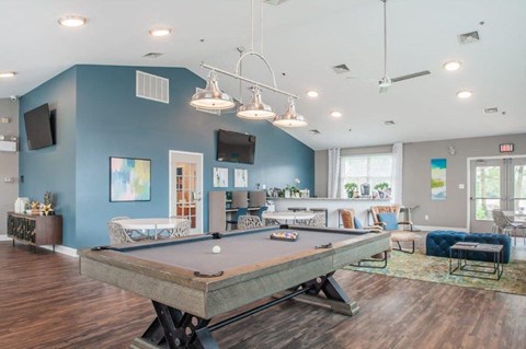 a game room with a pool table and a television