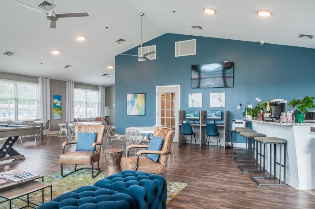 a living room with chairs and a bar and a television