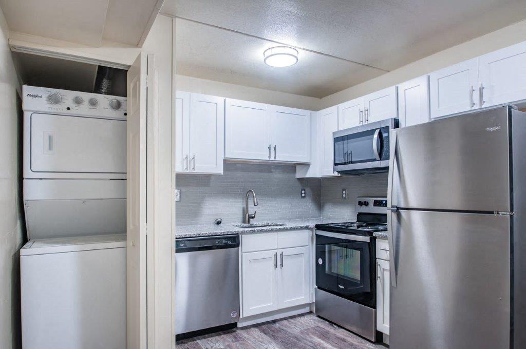a kitchen with stainless steel appliances and white cabinets
