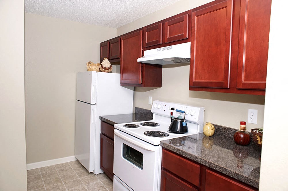a kitchen with white appliances and granite counter tops
