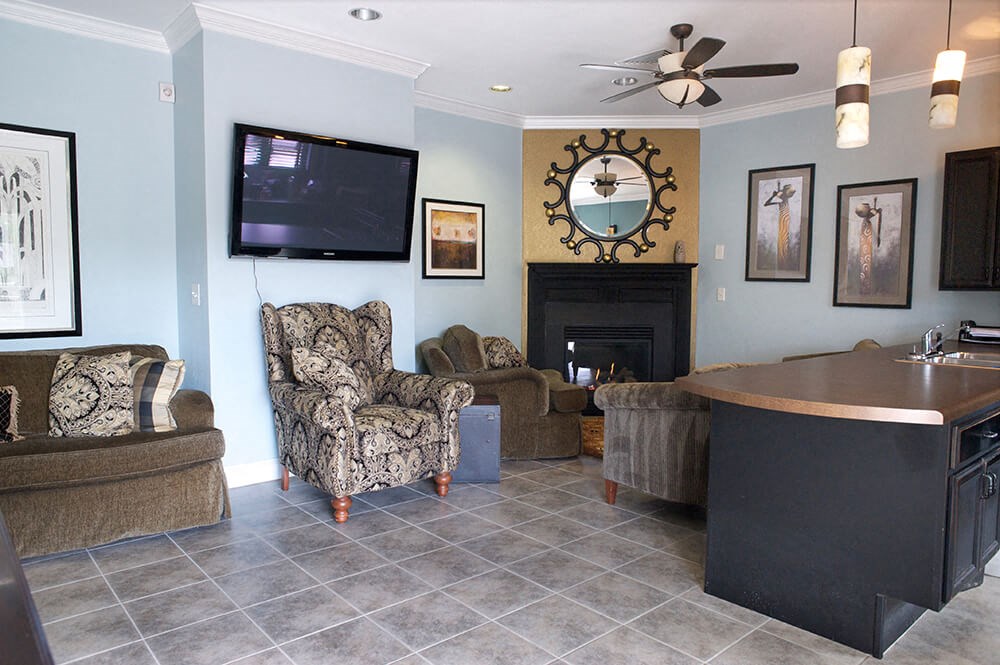 a living room with couches a table and a television