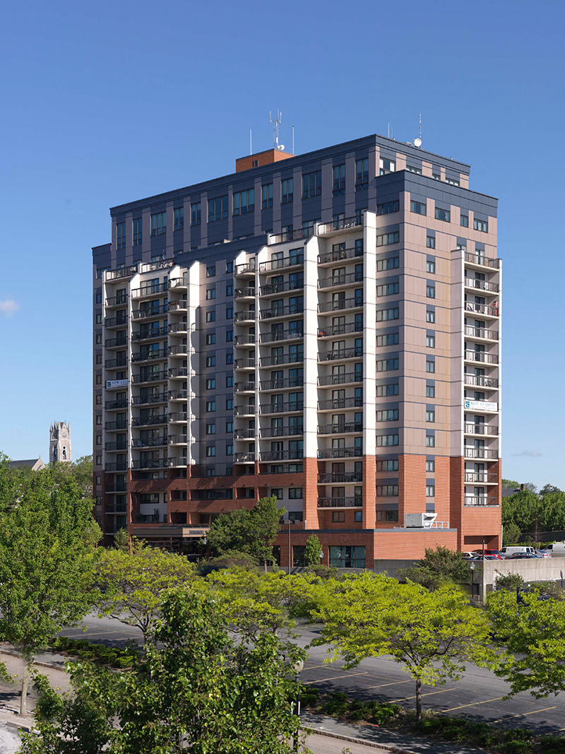 a tall building with trees in front of it