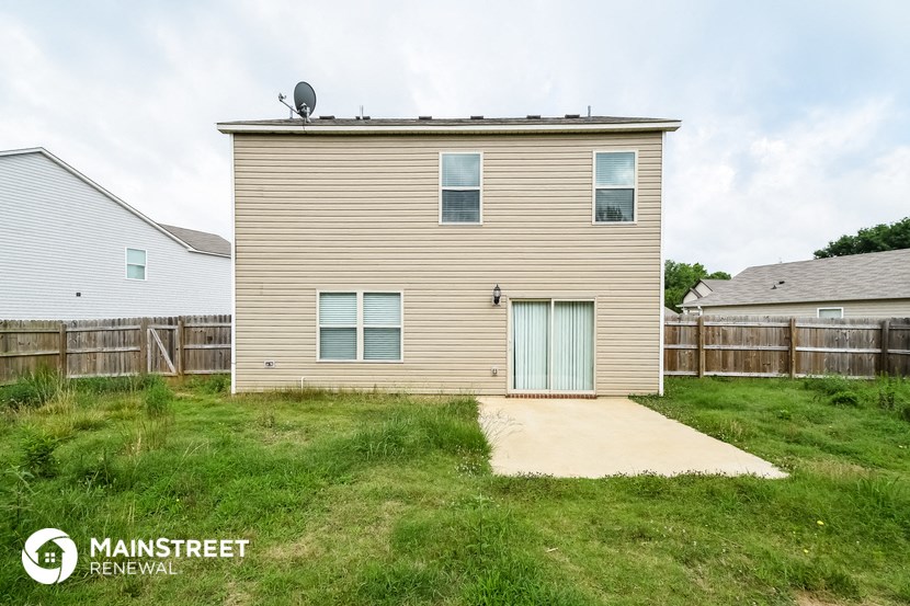 a small house with a blue door on the side of it