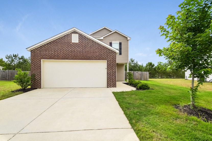 a house with a white garage door and a driveway
