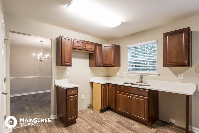 the kitchen of a new home with wooden cabinets and a white counter top