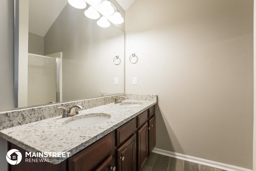 a bathroom with two sinks and a large mirror
