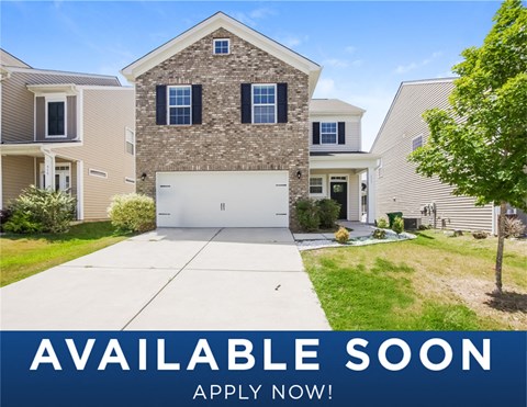 a suburban home with a garage door on a sidewalk