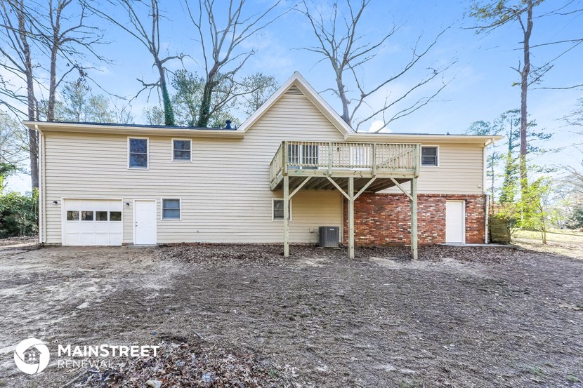 the front of a house with a deck and a garage