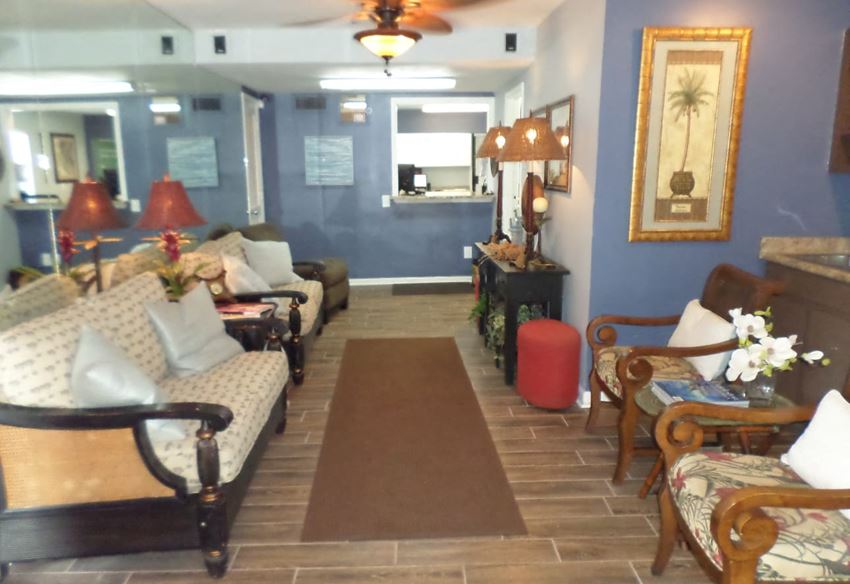 a living room with couches and chairs and a rug