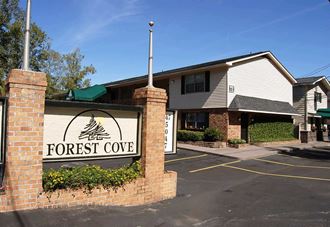 a building with a forest cove sign in front of it