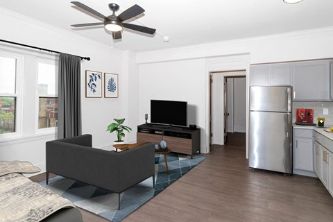 A living room with a grey couch and a television.