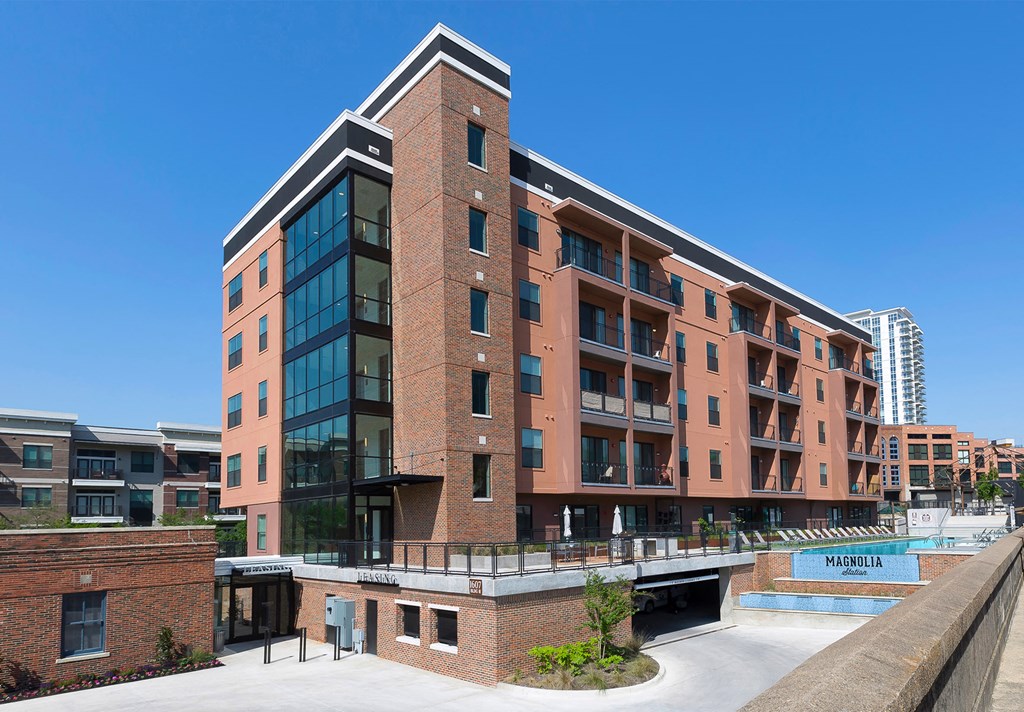 a large red brick building with a balcony and a bridge