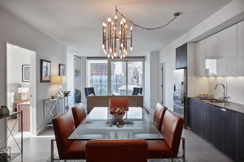 a dining room with a glass table and chairs