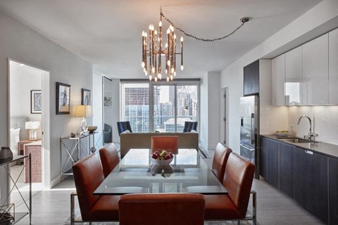 a dining room with a glass table and chairs