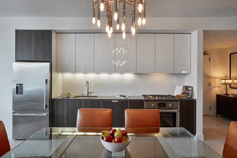 a kitchen with a bowl of fruit on a table