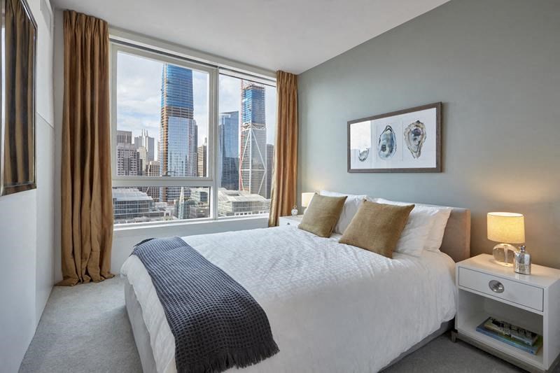 a bedroom with a bed and a large window