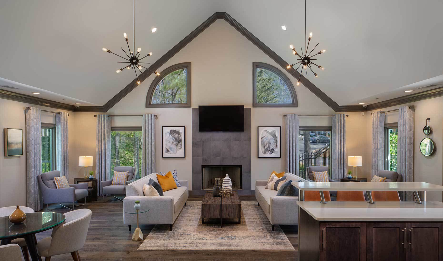 a living room with couches and chairs and a fireplace