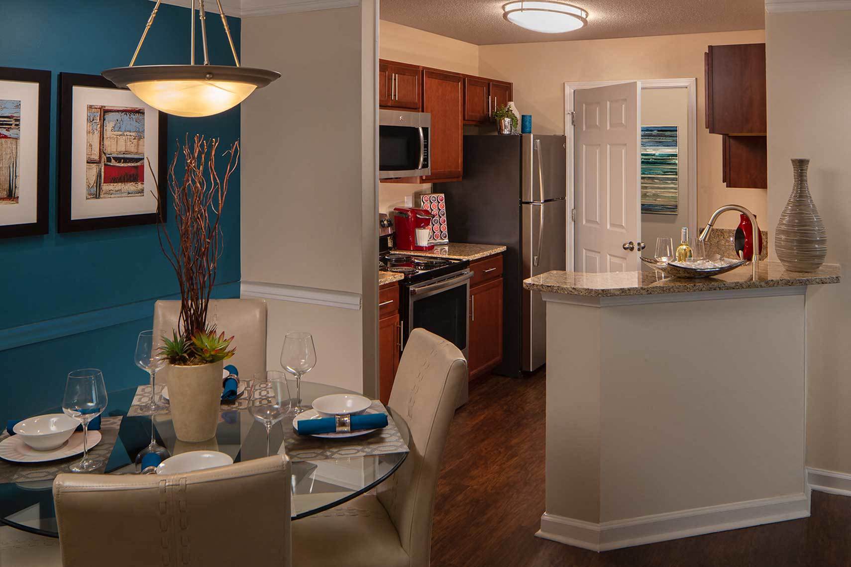 Kitchen with stainless steel appliances, bar area and wood style flooring