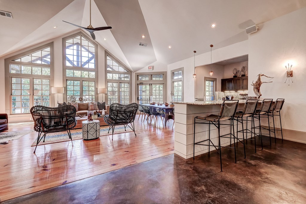 a large living room with a bar and a dining room