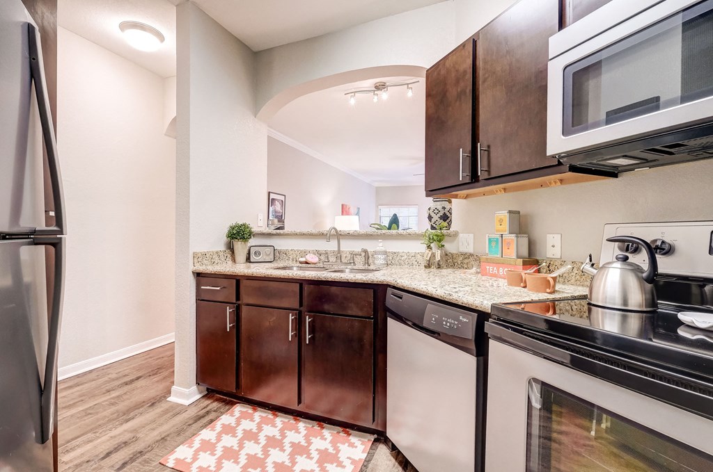 a kitchen with stainless steel appliances and granite counter tops