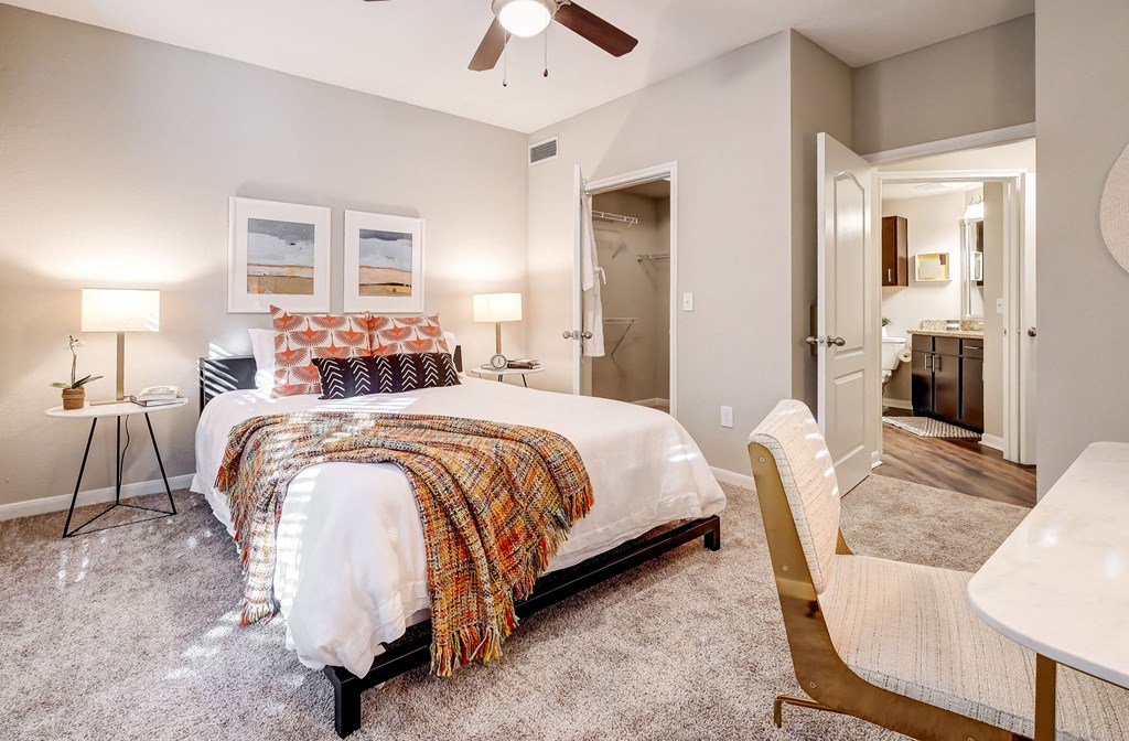 a bedroom with a bed and a ceiling fan