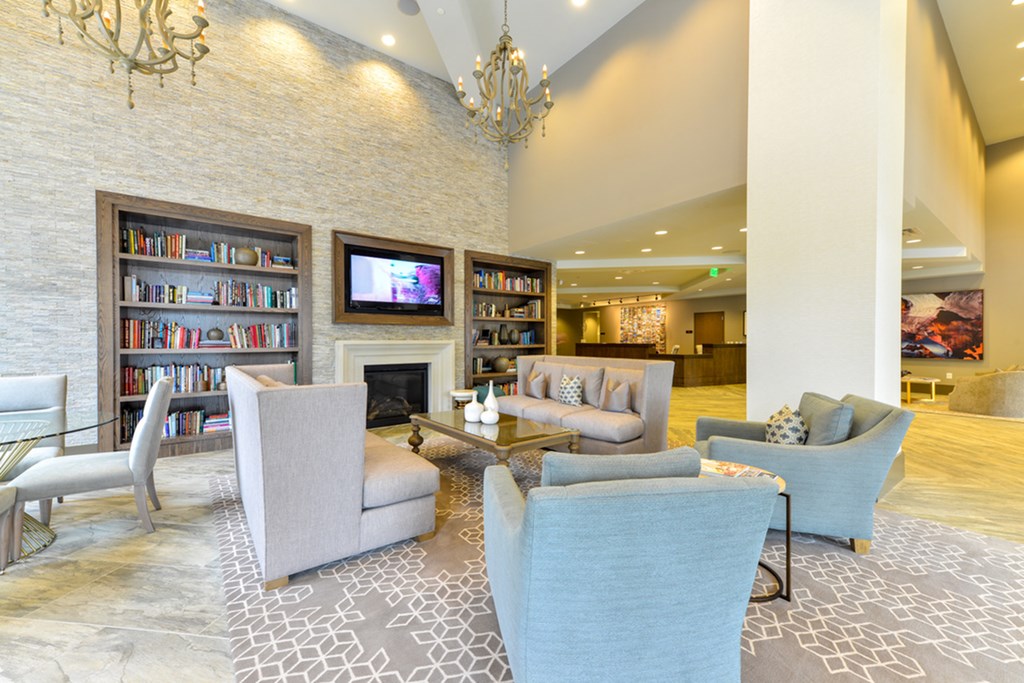 a living room with couches and chairs and a fireplace