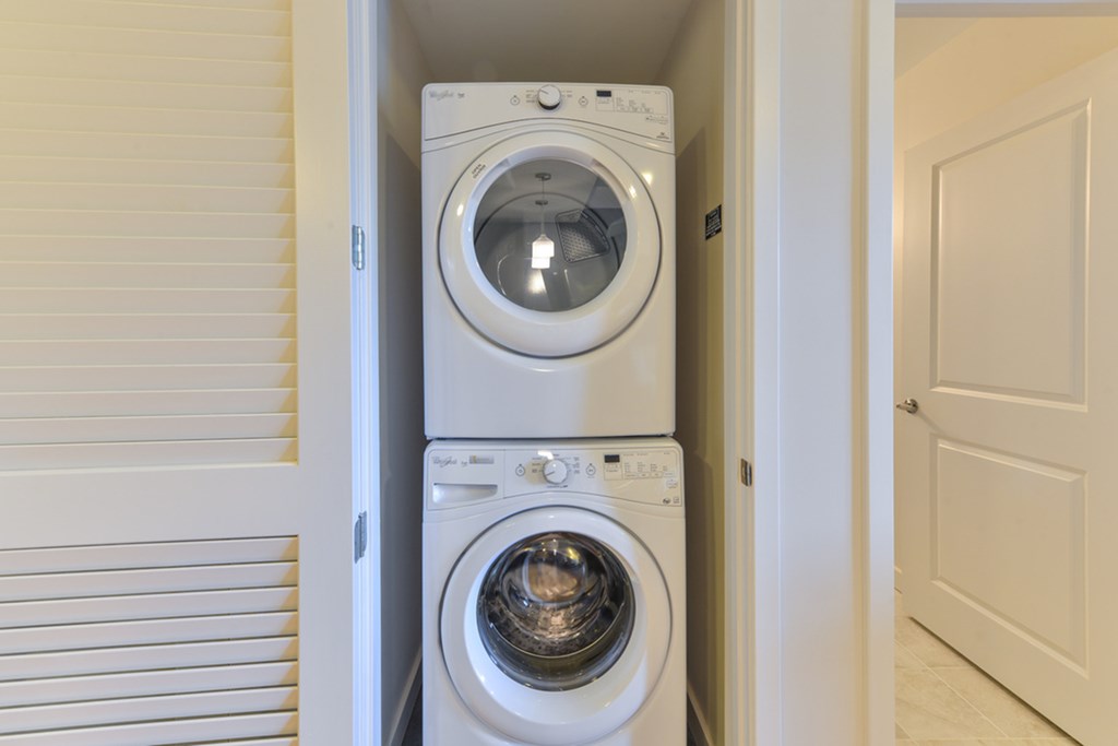 a front loading washer and dryer in a laundry room