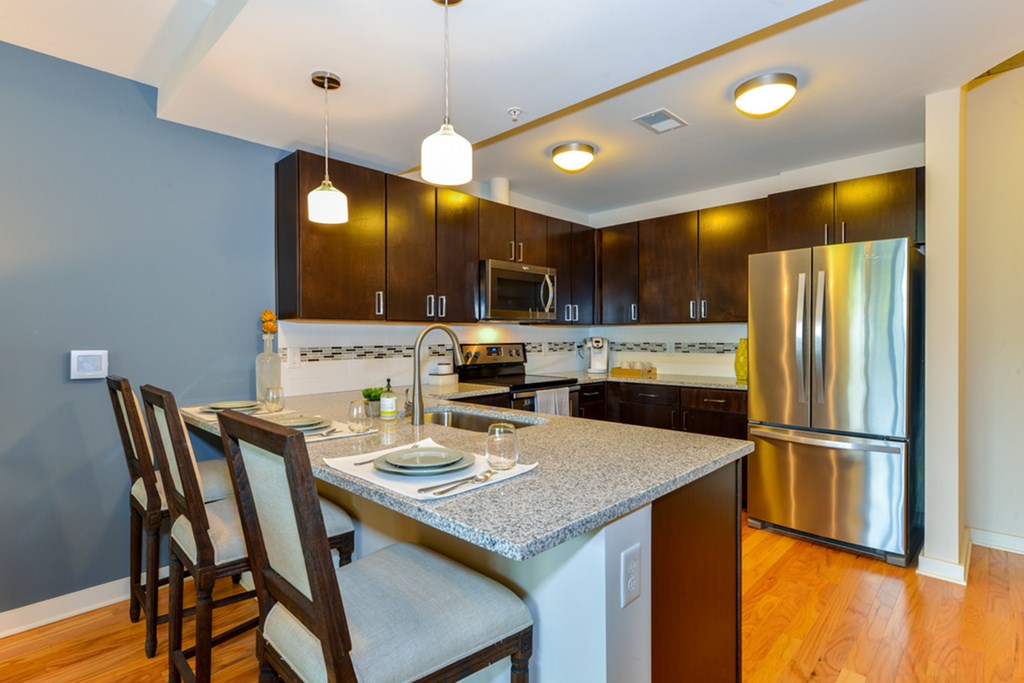 a kitchen with stainless steel appliances and granite counter tops
