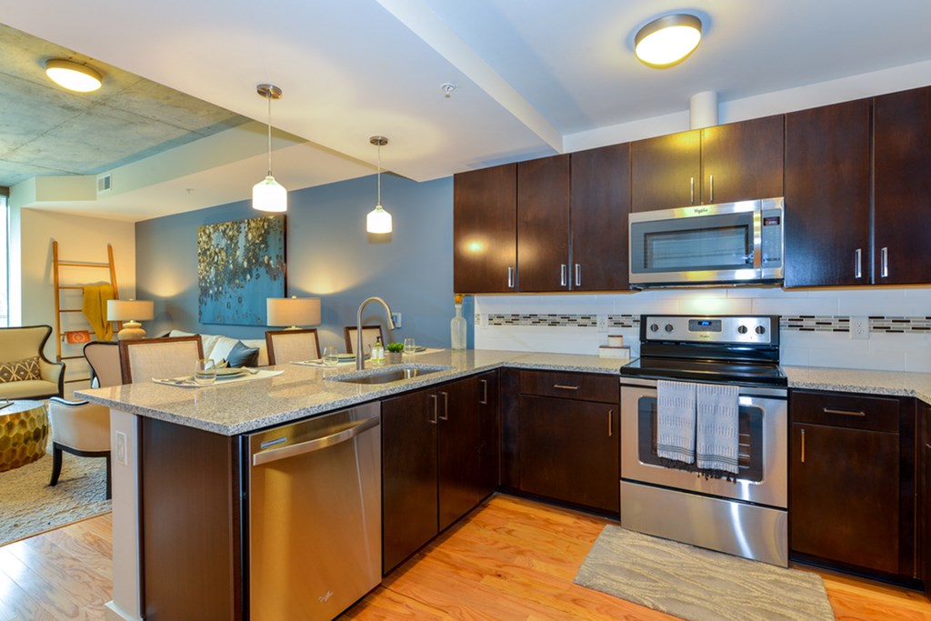 a large kitchen with stainless steel appliances and a counter top