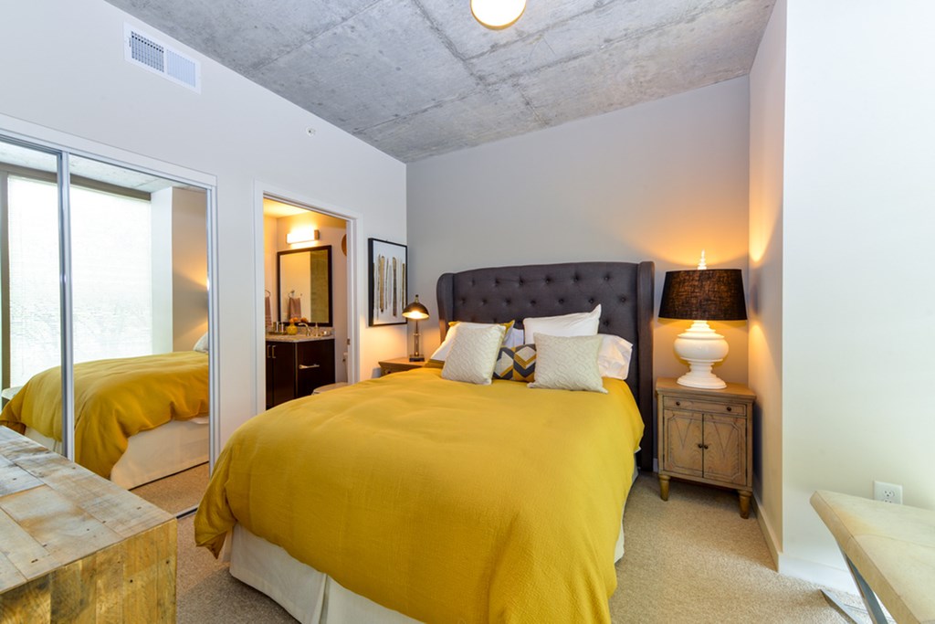 a bedroom with a large yellow bed and a window