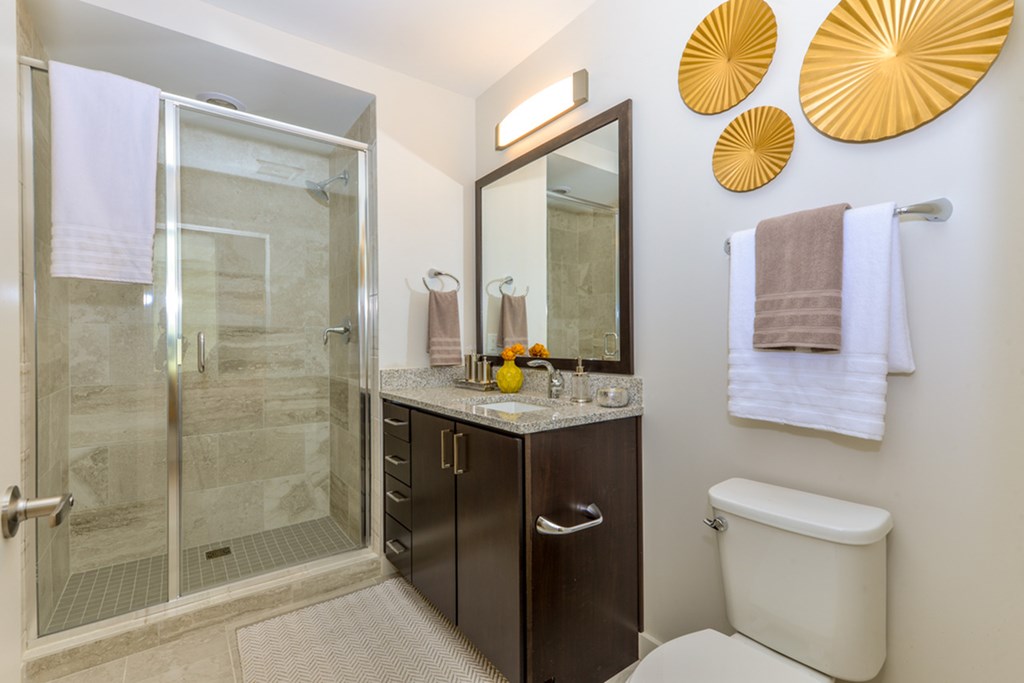 a bathroom with a shower and a sink and a toilet