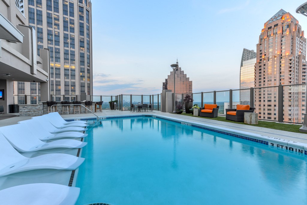 a swimming pool on the roof of a building in the city
