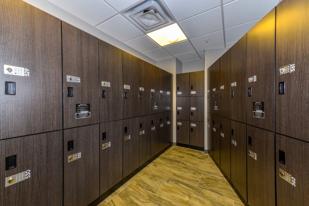 a row of lockers in a room with a wooden floor and floor lockers