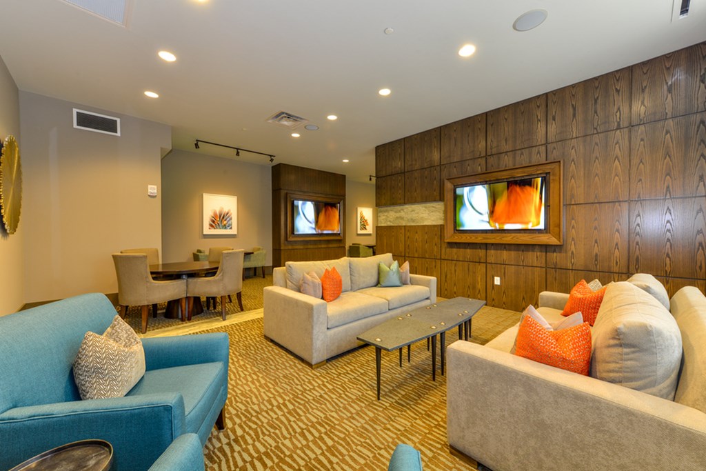 a living room with couches and chairs and a table