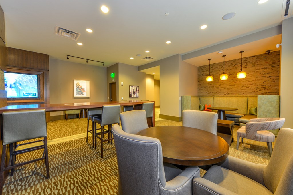 a dining area with a table and chairs and a bar