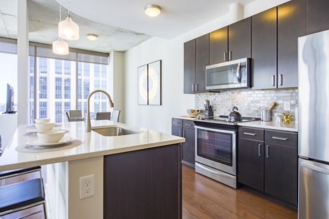 a kitchen with a large counter top and a sink and a microwave