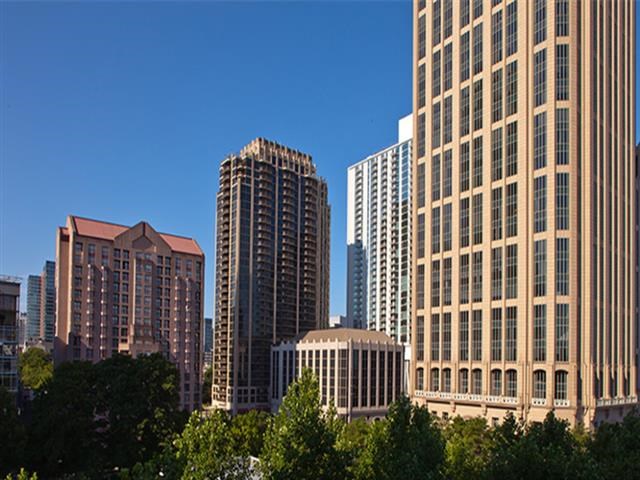 a city skyline with tall buildings and trees