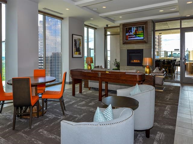a living room with a table and chairs and a fireplace