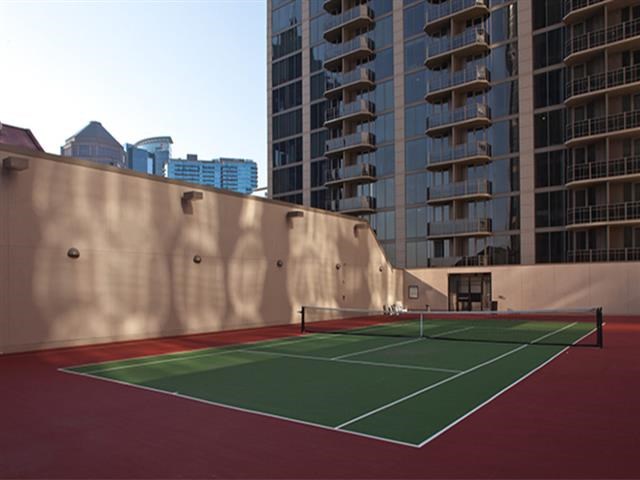 a tennis court in the middle of a city