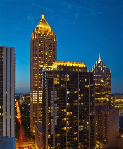 a city skyline with tall buildings at night