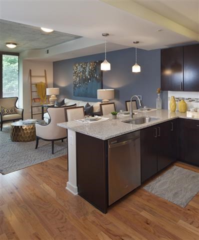 a kitchen with an island and a living room