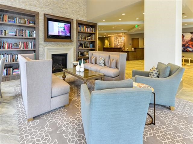 a living room with blue furniture and a fireplace