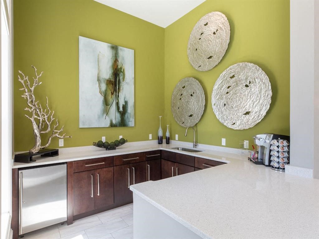 a kitchen with a counter and three hats on the wall