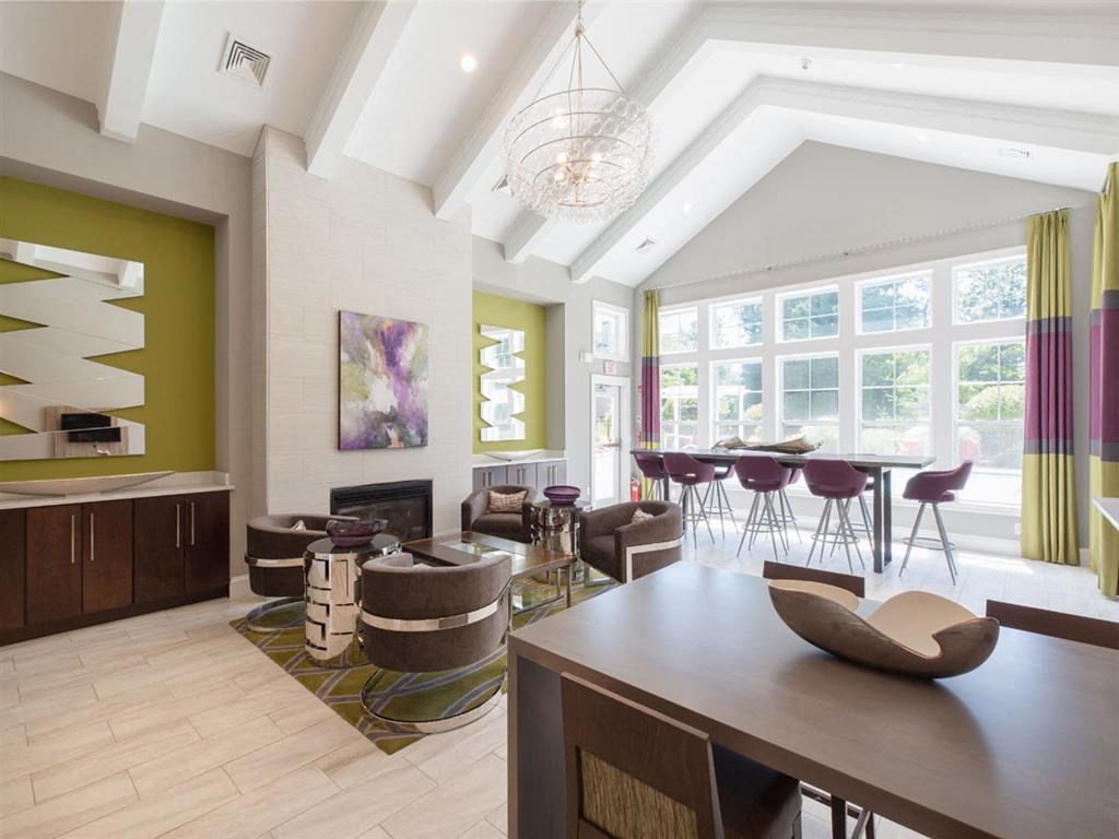 a living room and dining room with a table and chairs
